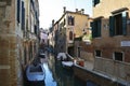 Venice, Italy, October 2021: View of a narrow canal surrounded by old brick houses in Venice. Royalty Free Stock Photo