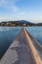 View narrow concrete long pier in Kanoni Corfu Greece, which connects Kanoni and Perama The ideal place for spotting. The planes