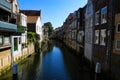 View on narrow dutch water canal with residential houses on both sides against blue summer sky - Dordrecht, Netherlands Royalty Free Stock Photo