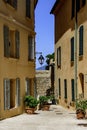 View of a narrow picturesque French street in Saint-Tropez with yellow colored buildings