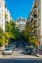 view of a narrow street in the central athens with lycabetus hill at the end....IMAGE