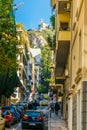 view of a narrow street in the central athens with lycabetus hill at the end....IMAGE