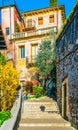 view of a narrow street with colorful houses along the way to the castel san pietro in the italian city Verona...IMAGE