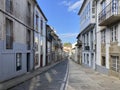 View of a narrow street of Santiago de Compostela, the final destination of the pilgrimage Camino de Santiago, Galicia, Spain.