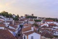 View of narrow streets and castle of Obidos from wall of fortress. Scenic old town with medieval architecture in the sunset. White Royalty Free Stock Photo