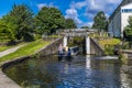 A view of a narrowboat entering the bottom of three locks gates on the Leeds, Liverpool canal at Bingley, Yorkshire, UK