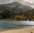 A view of the natural Lake Tsivilu Peloponnesus, Greece and mountains around on a cloudy winter day Royalty Free Stock Photo