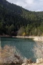 A view of the natural Lake Tsivilu Peloponnesus, Greece and mountains around on a cloudy winter day Royalty Free Stock Photo