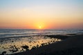 View of natural rocky beach and cliff with palm trees in El Tunco, El Salvador. Stones and rocks on the beach at sunset or sunrise Royalty Free Stock Photo