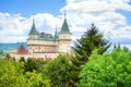 View of neogothic Bojnice castle over treetops of Castle park Bojnice, Slovakia Royalty Free Stock Photo