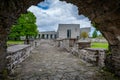 View of the new monastery building through the arch of the old building. Royalty Free Stock Photo