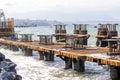 View of the new pier piles of the harbor. A pile or piling is a vertical structural element of a deep foundation, driven or drille Royalty Free Stock Photo