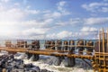 New pier piles of the harbor. A pile or piling is a vertical structural element of a deep foundation Royalty Free Stock Photo