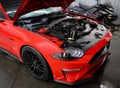 View of a new red Ford Mustang with an open hood