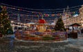 A view of the New Year`s fair decorated with bright elution on Red Square, photo was taken on a winter evening Royalty Free Stock Photo