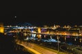 View of Newcastle Quayside and Tyne Bridge, illuminated at night on a clear evening. HMS Calliope and Helipad in foreground