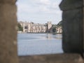 View Of Newstead Abbey Seen Through A Stone Arch Window Across The Lake