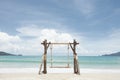 Wooden swing on summer tropic beach