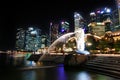 View of night central Singapore cityscape. Merlion lion fountain sculpture with financial tower building and night sky background