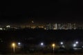 View of night city. Lights of multistoried buildings, bright street lamps. Urbanistic concept, city lights, moonlighting. Moon Royalty Free Stock Photo