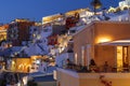 View of the night Fira with hotels, cafes and restaurants in the evening light. The island of Santorini,