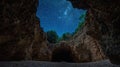A view of the night sky through a cave opening, with stars visible Royalty Free Stock Photo