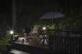 View night of wooden patio  of typical  wooden Swedish house with table, chairs and sitting area with umbrella.  . Royalty Free Stock Photo