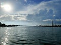 a view into the Nile river showing the river meets the blue incredible sky that has sun and clouds meeting into shores Royalty Free Stock Photo