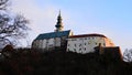 View of Nitra Castle with Saint Emeram Cathedral tower from northwestern side of park Sihot, in winter evening sunshine Royalty Free Stock Photo