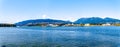 View of the North Shore of the Vancouver Harbor with the Lions Gate Bridge in the distance. Royalty Free Stock Photo