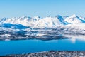 View of the Norwegian city of Tromso in Norway and snowy mountains and fjords beyond Royalty Free Stock Photo