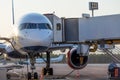 View of the nose and cockpit of the aircraft and the docking gangway air bridge Royalty Free Stock Photo