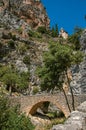 View of the Notre-Dame de Beauvoir church amidst cliffs and rock bridge.