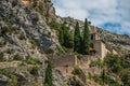 View of the Notre-Dame de Beauvoir church amidst cliffs and rock stairway, above the Moustiers-Sainte-Marie village. Royalty Free Stock Photo