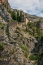 View of the Notre-Dame de Beauvoir church amidst cliffs and rock stairway, above the Moustiers-Sainte-Marie village. Royalty Free Stock Photo