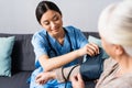 view of nurse measuring blood pressure