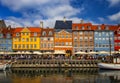 View of Nyhavn pier with color buildings, ships, yachts and other boats in the Old Town of Copenhagen, Denmark. Blue sky is in the Royalty Free Stock Photo