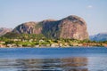 View from Oanes to Forsand city. Cottages under a huge cliff. Royalty Free Stock Photo