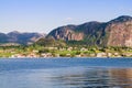 View from Oanes to Forsand city. Cottages under a huge cliff. Royalty Free Stock Photo