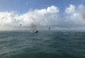 View of the ocean and ship through a window with raindrops Royalty Free Stock Photo