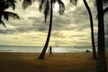 View of the ocean and the sunset sky on the beach in Hawaii United States, August 2012 with man and palm trees silhouetted in th Royalty Free Stock Photo