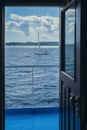 View on the ocean and yachts from open door of captain cabin Royalty Free Stock Photo