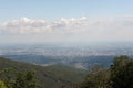 View od Croatia capital Zagreb from Medvednica, Sljeme mountain with green forest, blue sky and white clouds.