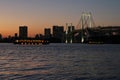 View from Odaiba Beach to Tokyo Bay with Rainbow Bridge at dusk