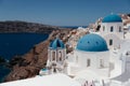 View of Oia town with church and blue dome in Santorini island in Greece. Royalty Free Stock Photo