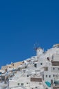 View of Oia town in Santorini with old white houses and windmill Royalty Free Stock Photo