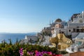 View of Oia town in Santorini with old white houses and windmill