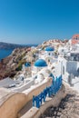 View of Oia town with traditional and famous houses and churches with blue domes over the Caldera on Santorini island. Royalty Free Stock Photo