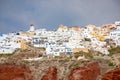 View of Oia village with white houses on red rocks caldera of Santorini Island, Greece Royalty Free Stock Photo