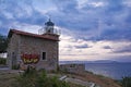 Abandoned stone lighthouse under a dramatic sky, Greece. Royalty Free Stock Photo